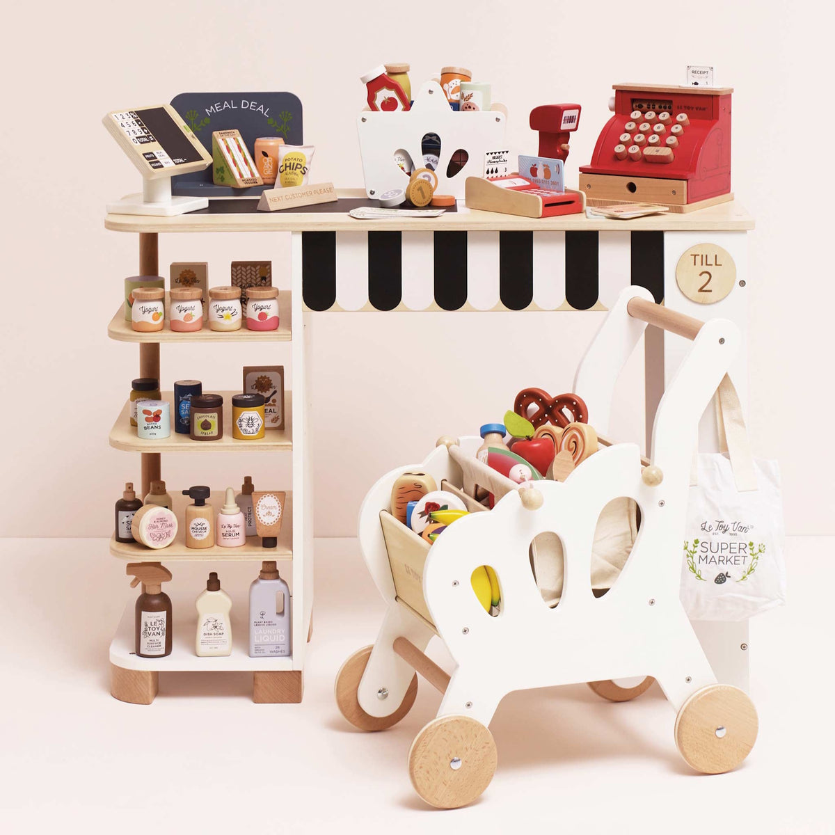 Wooden grocery shop play set with cash register, stocked shelves, and shopping cart.