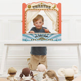 Young boy putting on a show using a wooden tabletop puppet theatre for soft dolls.
