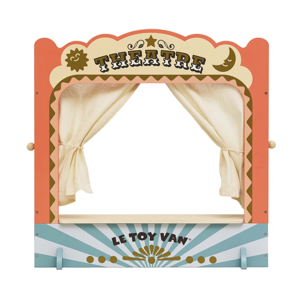 A colorful wooden toy puppet theater with cream curtains closed. The top reads "Theatre" in bold letters, conveying a playful and creative mood.