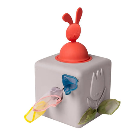 Gray pop-up tissue box toy featuring a red bunny topper and colorful fabrics pulling out from side slots.