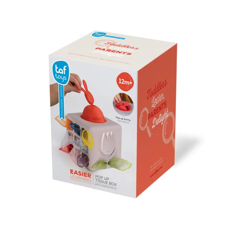 Taf Toys Pop Up Tissue Box packaging showing a child pulling the red pop-up bunny on a clean background.