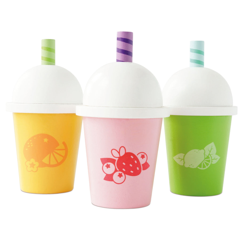 Three colorful cups with white domed lids and striped straws. Each cup has fruit designs: orange on yellow, strawberry on pink, lime on green. Vibrant and playful.
