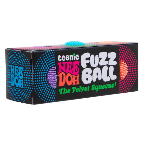 A black Teenie NeeDoh Fuzz Ball box displaying colorful text and windows showing the textured toys inside.