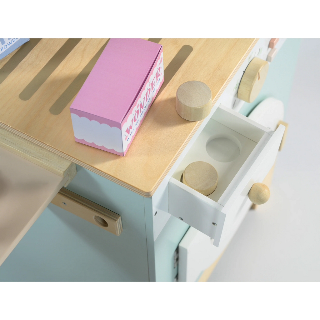 Wooden play set featuring a miniature washing machine, ironing board, and laundry accessories for imaginative role play and tidy-up fun.