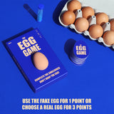 The Egg Game set with blue box, sand timer, egg-shaped cards, and a carton of real eggs.