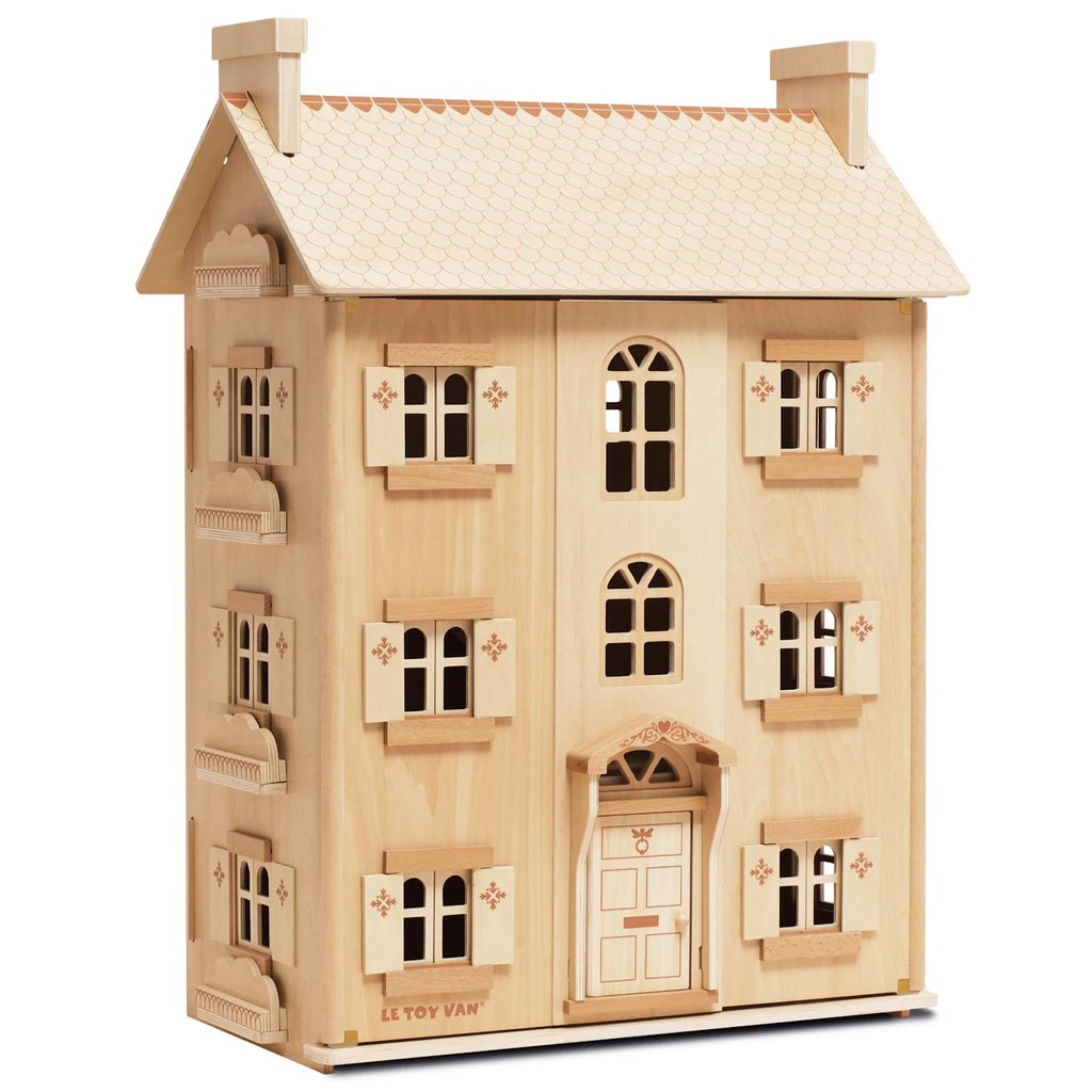 Wooden dollhouse with a beige facade, featuring multiple windows with shutters and a detailed front door. The roof is gabled, adding charm.