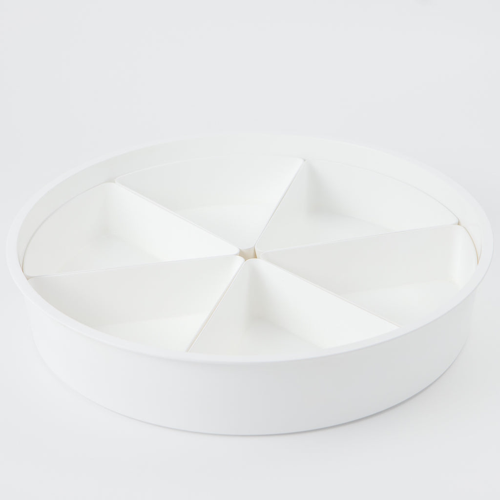 A white sensory play tray with compartments.