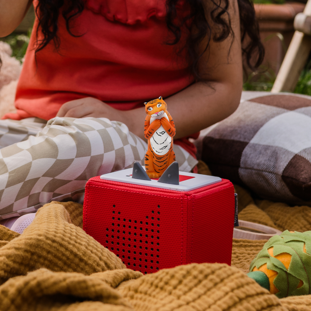 A playful orange tiger figurine, exuding a whimsical and cheerful vibe.