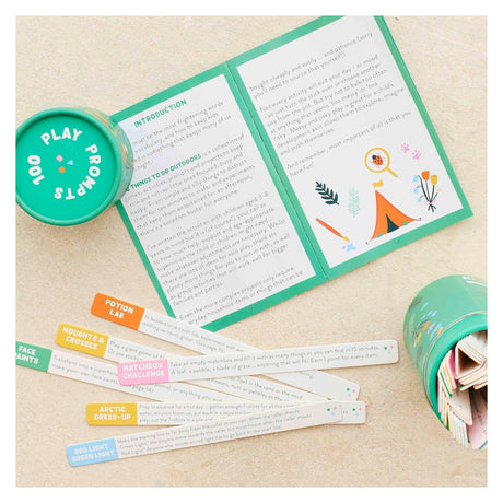 Open "100 Play Prompts" activity set with an instruction booklet, circular box, and colorful wooden sticks.