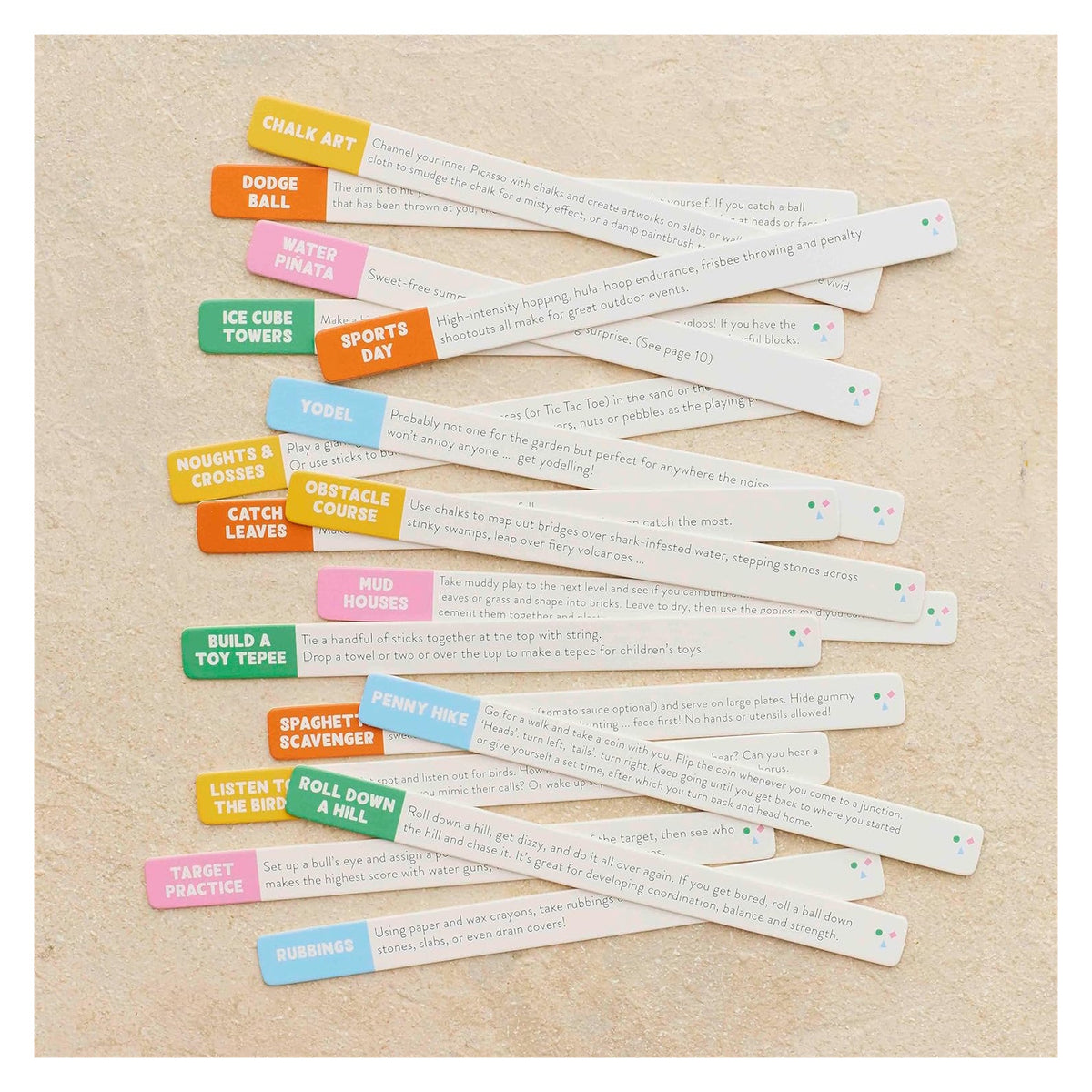 Colorful activity sticks with printed outdoor play prompts, including "Roll Down a Hill" and "Penny Hike."