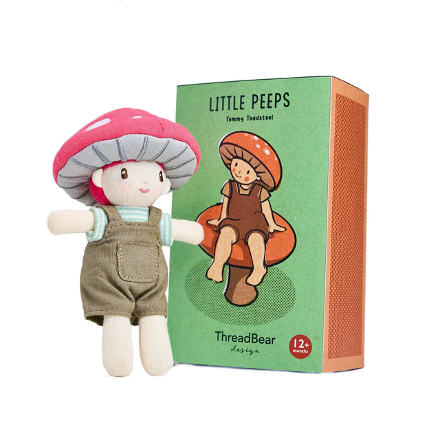 Small "Little Peeps Tommy Toadstool" plush doll standing beside its green illustrated box.