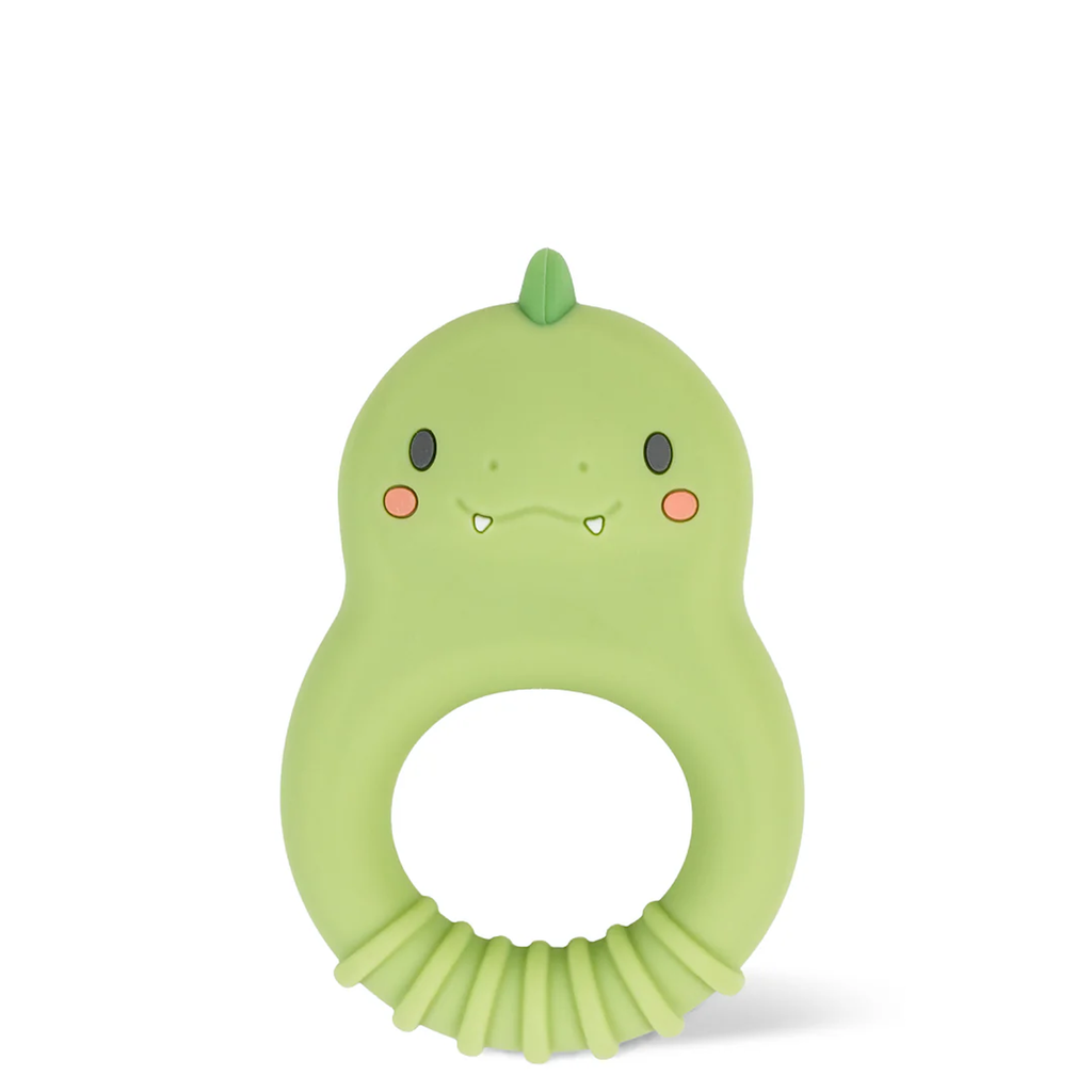 Cute green dinosaur-shaped baby teether with a smooth texture, featuring a small ridge, friendly face, and blush cheeks, conveying a playful tone.
