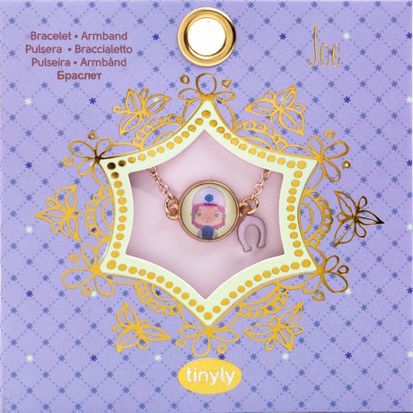 A children's bracelet from Djeco's Tinyly collection featuring a gold-colored chain and a charm of Joe, a character depicted with a horse and a heart-shaped accessory.