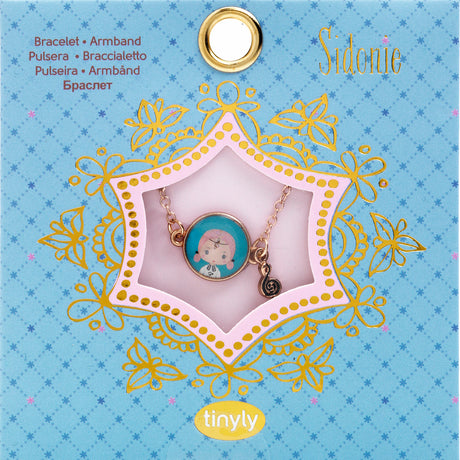 A children's bracelet from Djeco's Tinyly collection featuring a gold-colored chain and a charm of Sidonie, a character depicted with a musical note accessory.