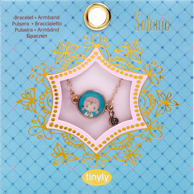 A children's bracelet from Djeco's Tinyly collection featuring a gold-colored chain and a charm of Sidonie, a character depicted with a musical note accessory.
