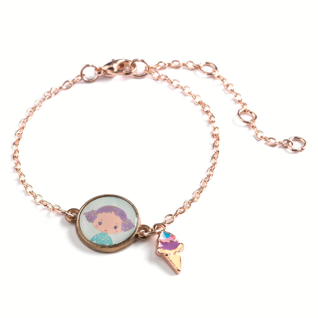 A children's bracelet from Djeco's Tinyly collection featuring a gold-colored chain and a pendant of Tutti, a character depicted with an ice cream accessory.