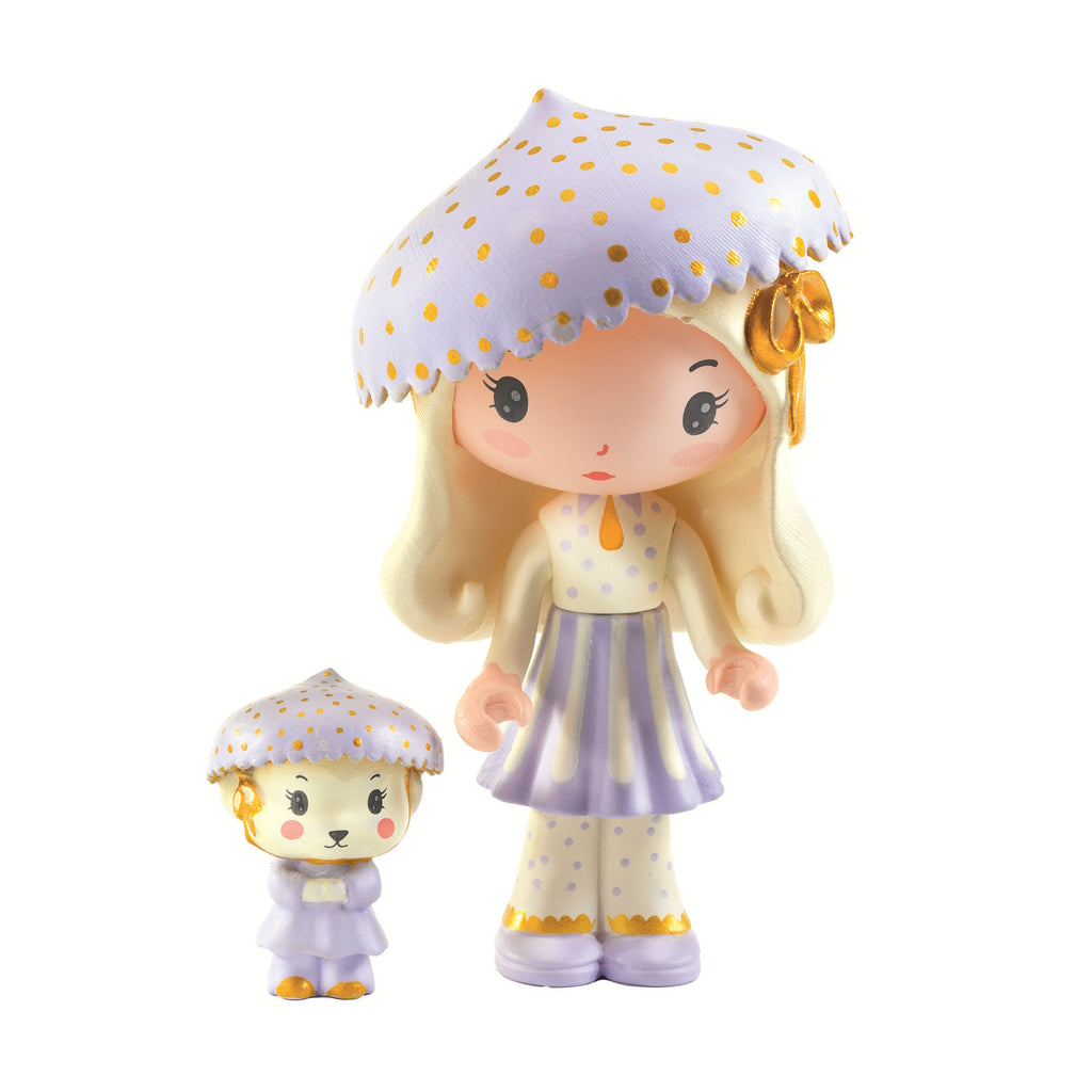 A whimsical green toy car adorned with pastel flowers, featuring two dolls, one wearing a polka-dot hat and the other a matching one.