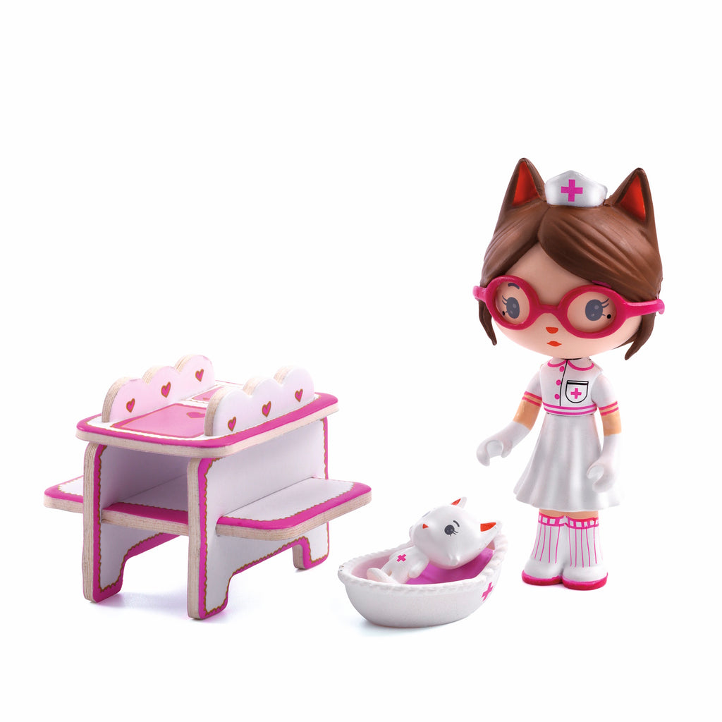 A playful scene featuring a nurse doll with cat ears, a white kitten, and a colorful, heart-themed room with shelves and toys.