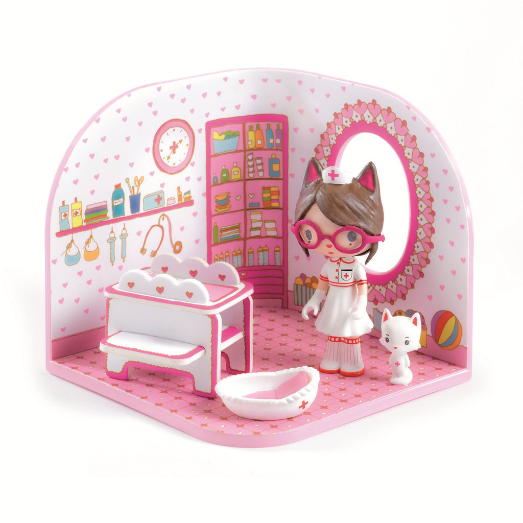 A playful scene featuring a nurse doll with cat ears, a white kitten, and a colorful, heart-themed room with shelves and toys.