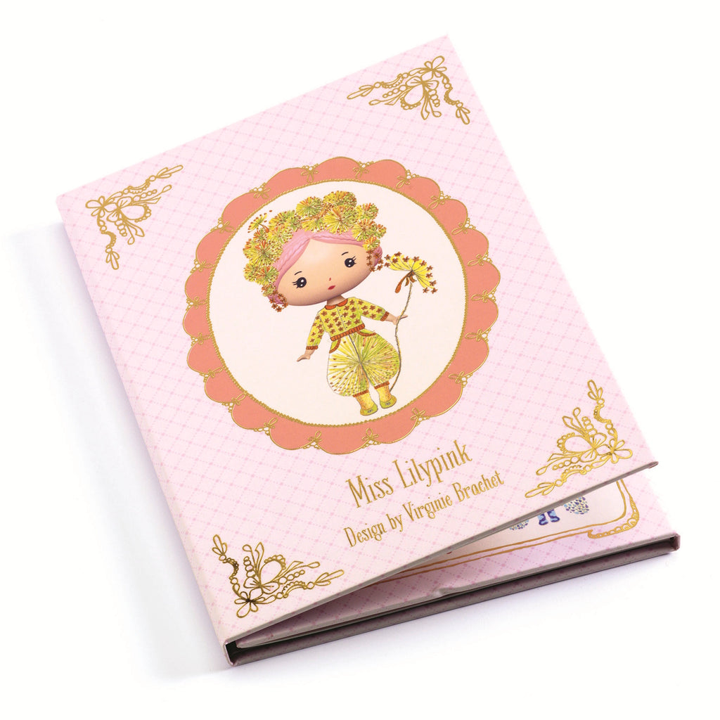 The set includes a cardboard booklet with a central illustration of Miss Lilypink and four sheets of reusable vinyl stickers, allowing children to dress and accessorize her in various outfits.
