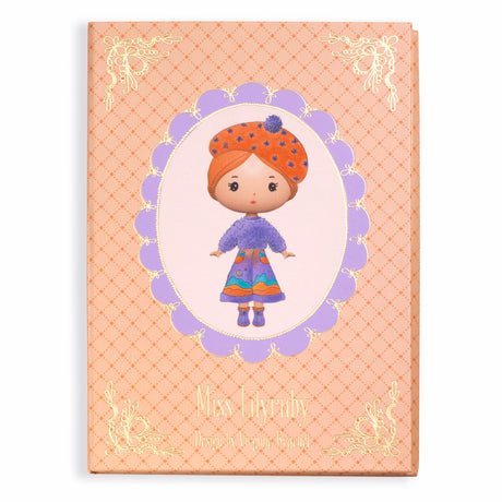 The set includes a fold-out booklet with a central illustration of Miss Lilyruby and four sheets of reusable vinyl stickers, allowing children to dress and accessorize her in various outfits.