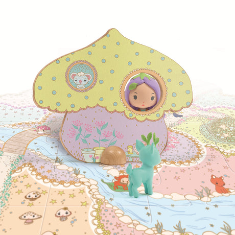 A colorful mushroom-shaped house with a doll peeking out, surrounded by a whimsical, illustrated landscape and a green toy deer. 