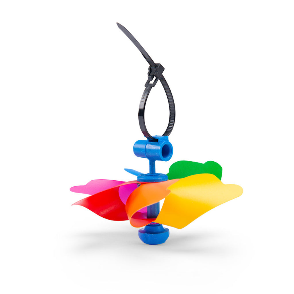 A colorful toy pinwheel with six vibrant blades in pink, red, orange, yellow, green, and blue against a white background, conveying a playful tone.