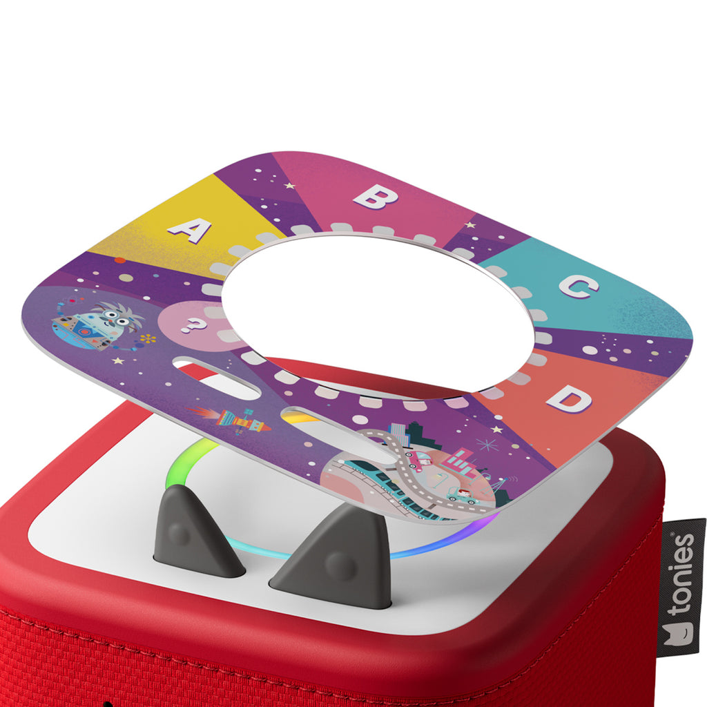 Colorful game spinner on a red Tonies box with labeled sections A-D. Playful design features cartoon animals, creating a fun, engaging atmosphere.