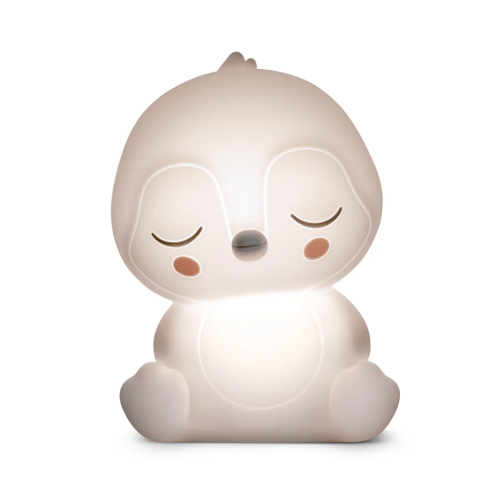 Cute, white penguin nightlight with closed eyes, blushing cheeks, and a serene expression. Its soft glow creates a calm and peaceful ambiance.