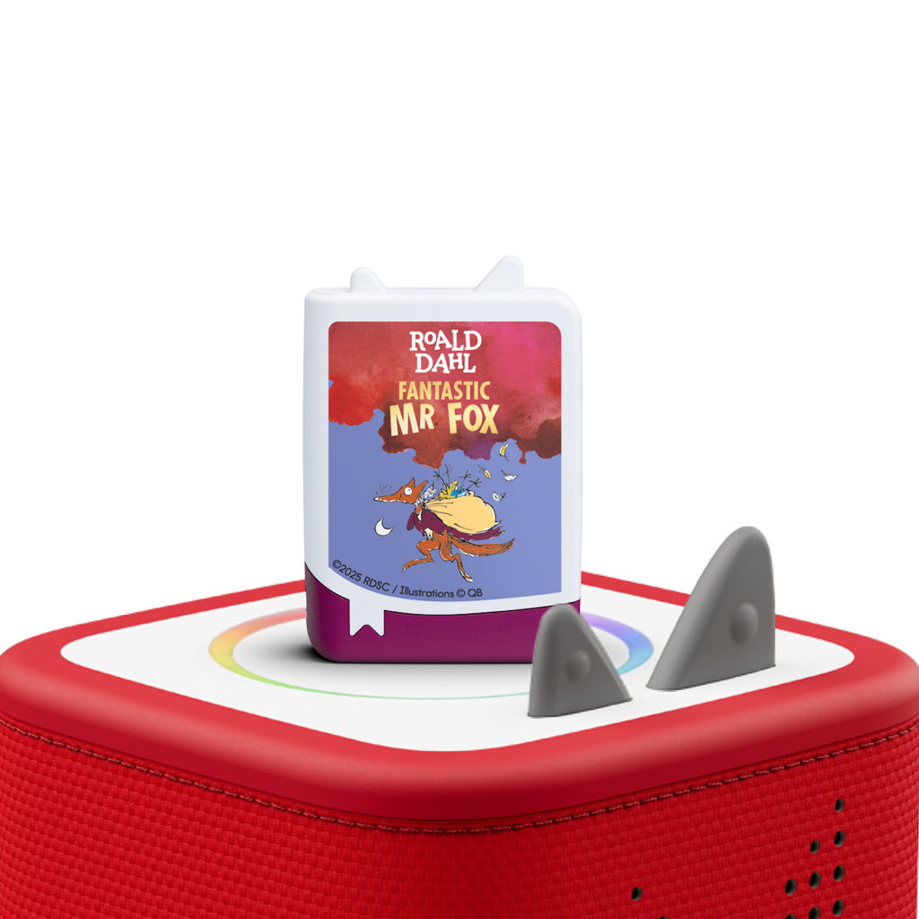 A small, rectangular audio device on a red speaker displays "Fantastic Mr. Fox" by Roald Dahl. It features a colorful illustration of a fox carrying a sack. The tone is playful and whimsical.