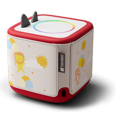 A Toniebox audio player with a white sleeve featuring lion, tiger, balloons, and sun illustrations.