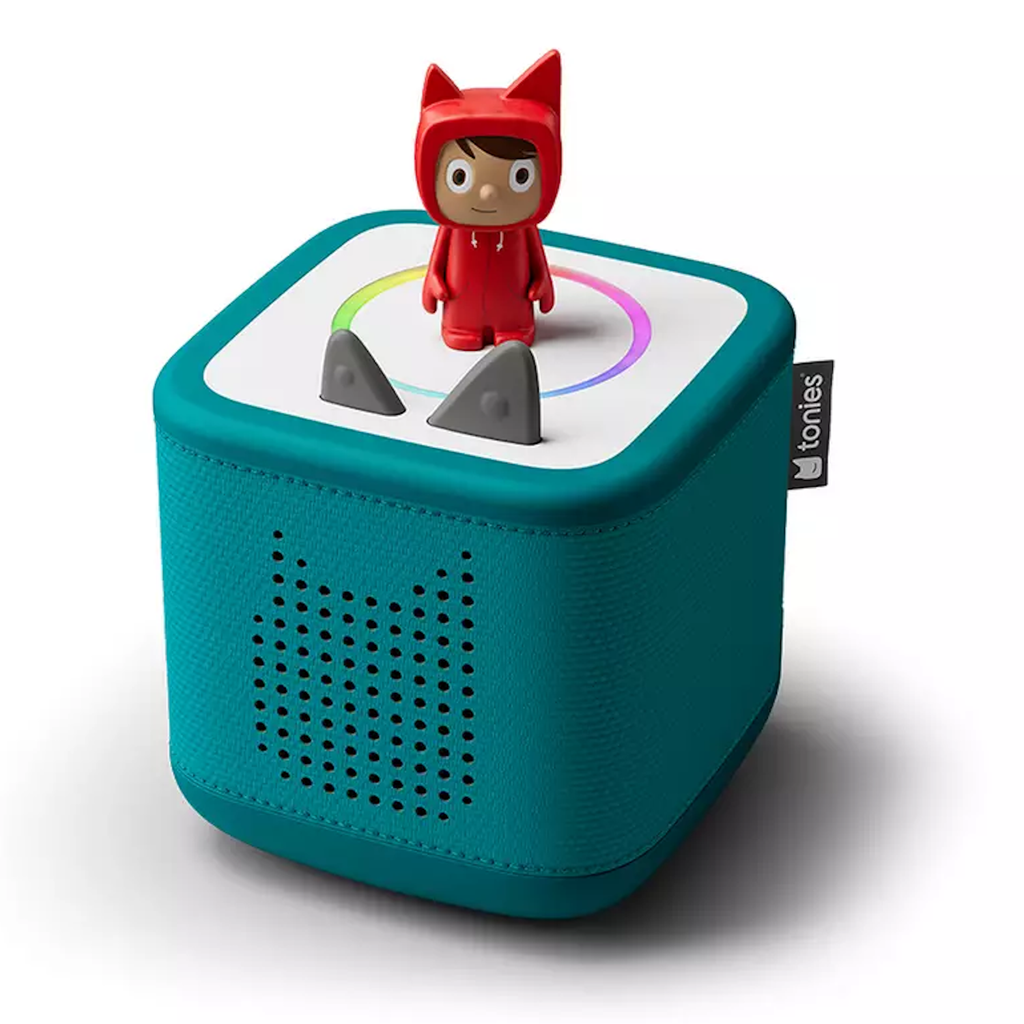 A teal Toniebox with a red figure in a cat costume on top. The box has cat-shaped speaker holes and playful, colorful accents, creating a fun, whimsical tone.