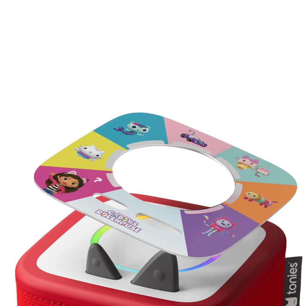 Colorful children's toy on a red and white box. Features a round cutout with cartoon characters in vibrant segments, conveying a playful tone.