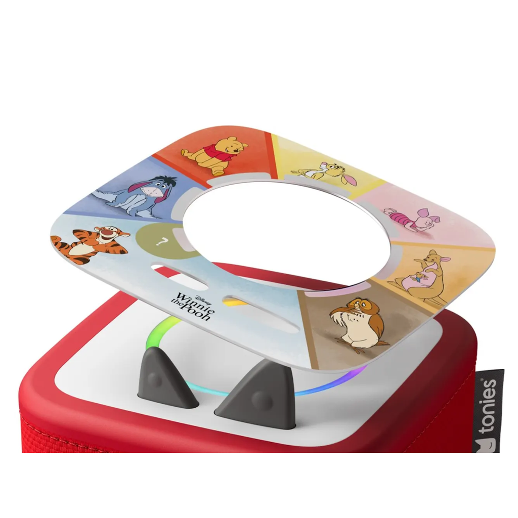 Red Toniebox with a colorful card on top featuring Winnie the Pooh characters like Pooh, Eeyore, Tigger, and Piglet. Simple and playful design.