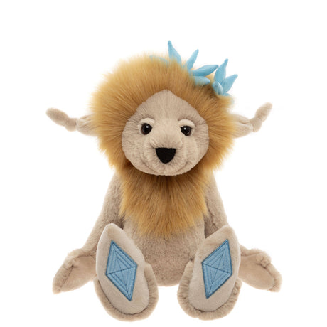 Front view of a plush cream creature with a fluffy golden mane, blue crown accents, and blue diamond foot pads.
