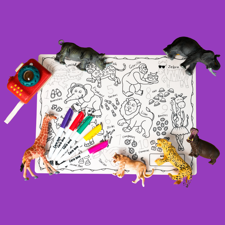 Toy safari animals and colorful markers arranged on a black-and-white animal coloring mat over a purple background.