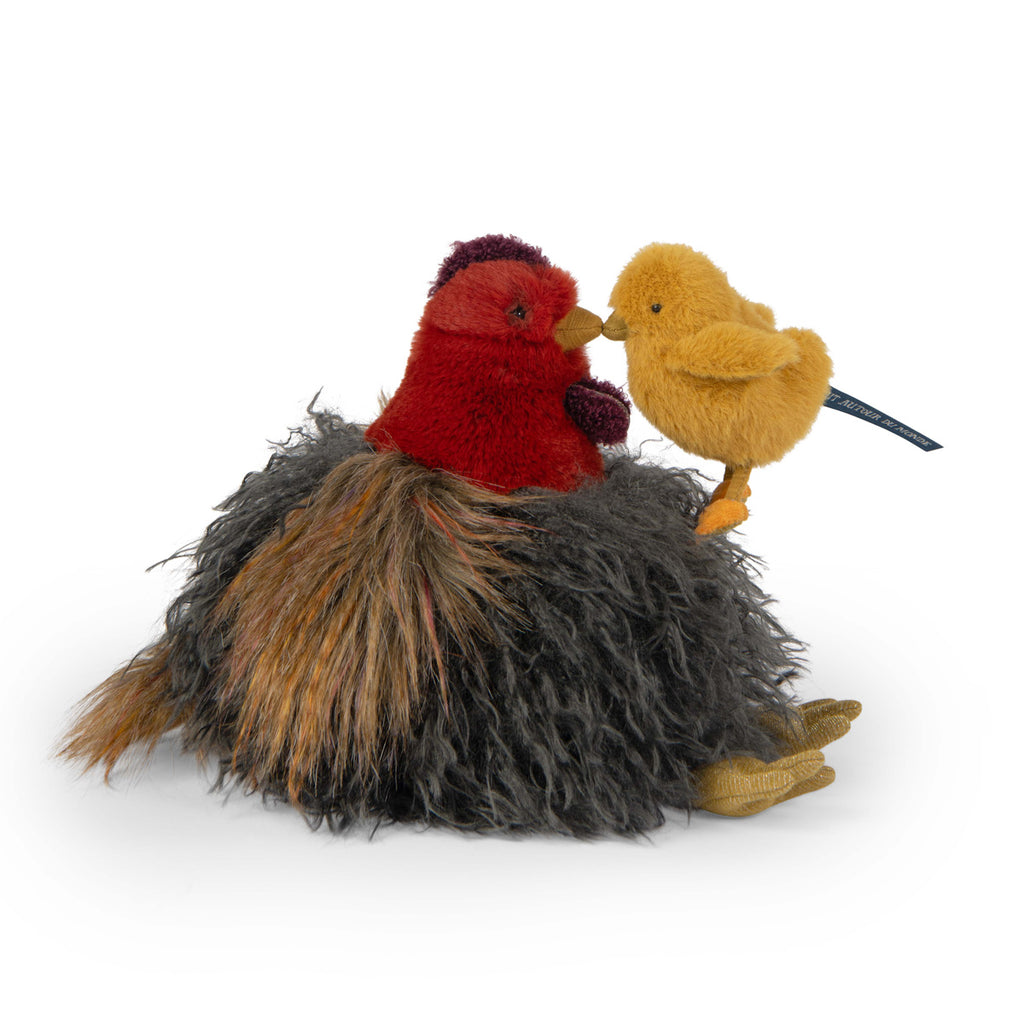 Two plush bird toys, one red with a fluffy gray and brown base, and the other yellow, gently touch beaks, conveying a tender, affectionate moment.