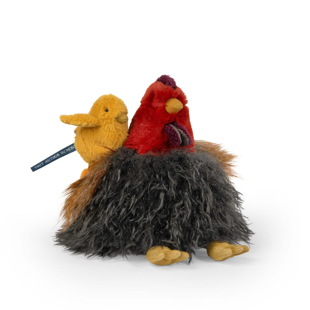 Two plush bird toys, one red with a fluffy gray and brown base, and the other yellow, gently touch beaks, conveying a tender, affectionate moment.