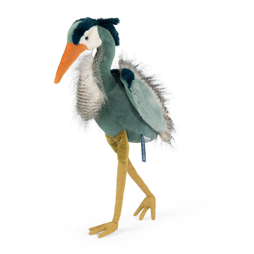 A plush toy resembling a heron with teal and grey feathers, an orange beak, and long yellow legs. It exudes a cute and whimsical charm.