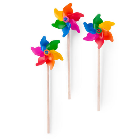 Three Moulin Roty multi-colored toy windmills with wooden sticks on a white background.