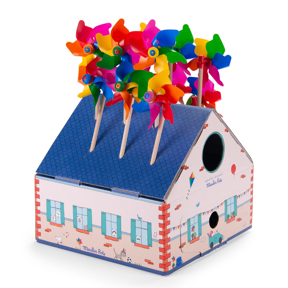 Moulin Roty colorful toy pinwheels displayed in a cardboard house box against a white background.