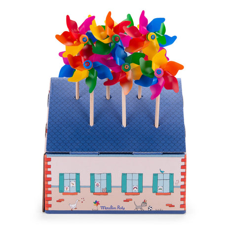 Moulin Roty colorful toy pinwheels in a decorative cardboard house display box.