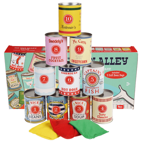 Stacked vintage game tin cans and colored bean bags positioned in front of their product box.