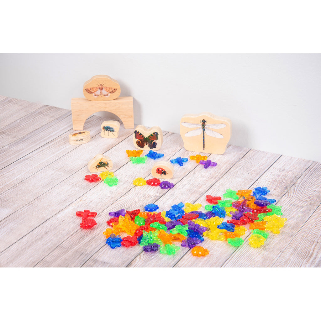 A set of colorful, see-through plastic bug figures designed for sensory play, sorting, counting, and light table exploration.