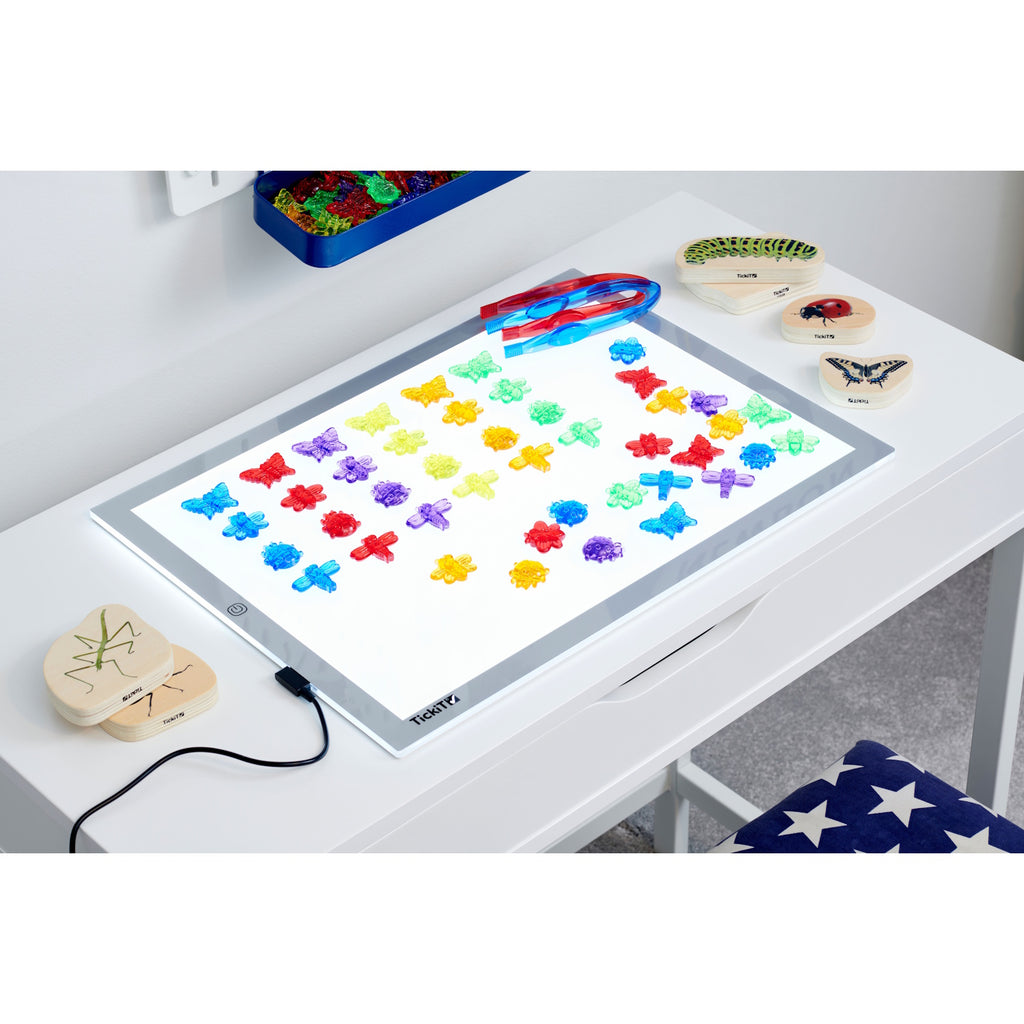 A set of colorful, see-through plastic bug figures designed for sensory play, sorting, counting, and light table exploration.