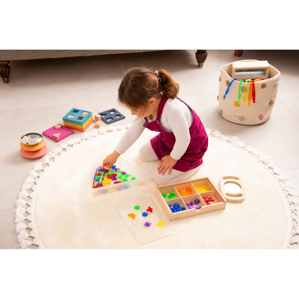 A set of colorful, see-through plastic bug figures designed for sensory play, sorting, counting, and light table exploration.