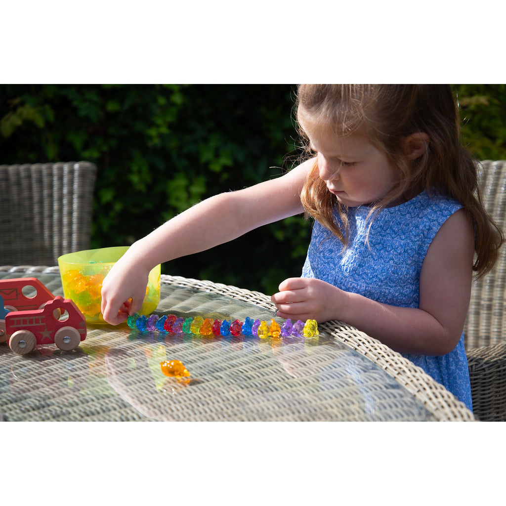 A set of brightly colored see-through fish figures, designed for sensory play, counting, sorting, and color recognition activities.