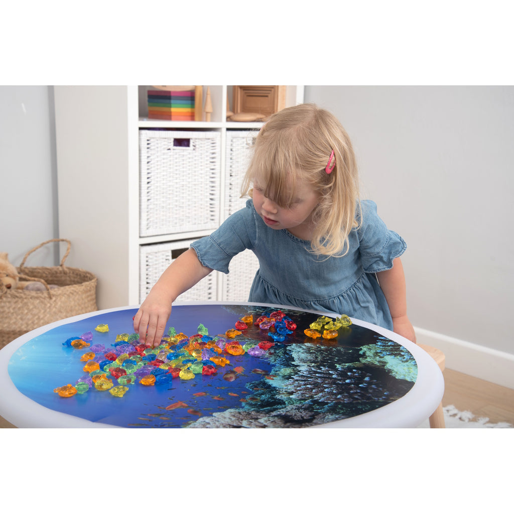 A set of brightly colored see-through fish figures, designed for sensory play, counting, sorting, and color recognition activities.