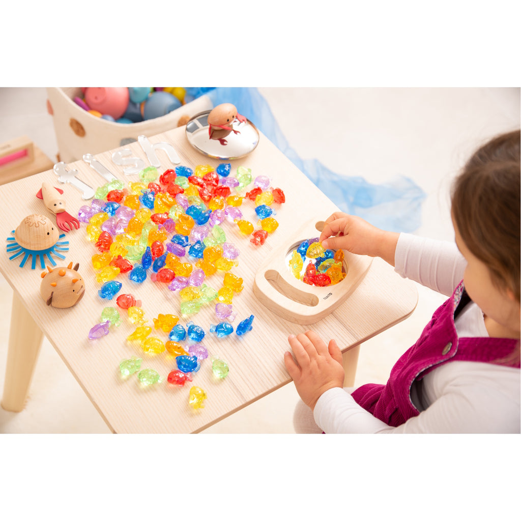 A set of brightly colored see-through fish figures, designed for sensory play, counting, sorting, and color recognition activities.