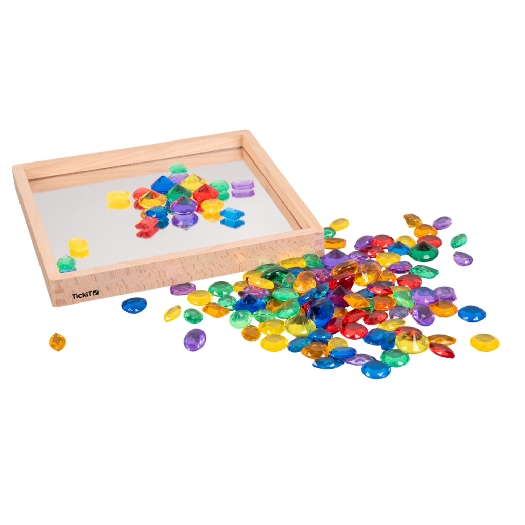 A collection of brightly colored, see-through plastic gems, ideal for sensory play, sorting, counting, and light table activities.